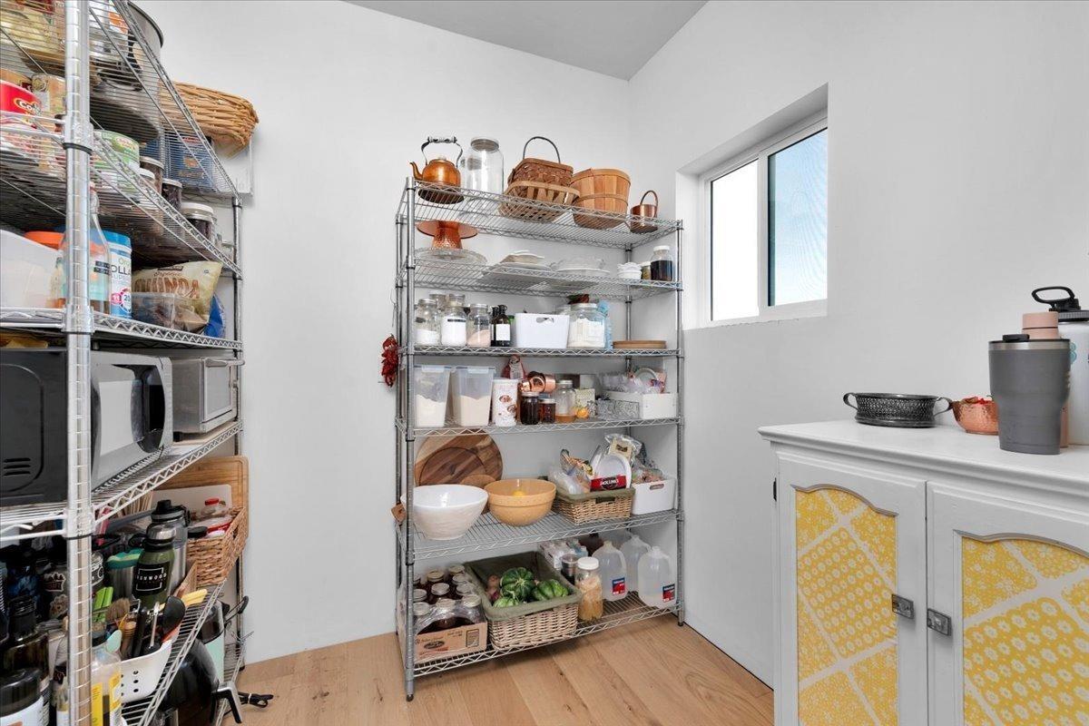 22654 Cobblestone Lane Sanger, CA 93657 - Photo 27 of 64 a kitchen with stainless steel appliances granite countertop a sink dishwasher and a wooden floor