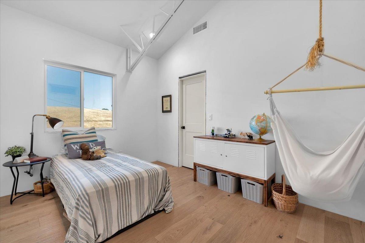 22654 Cobblestone Lane Sanger, CA 93657 - Photo 35 of 64 a bedroom with a bed a window and chair