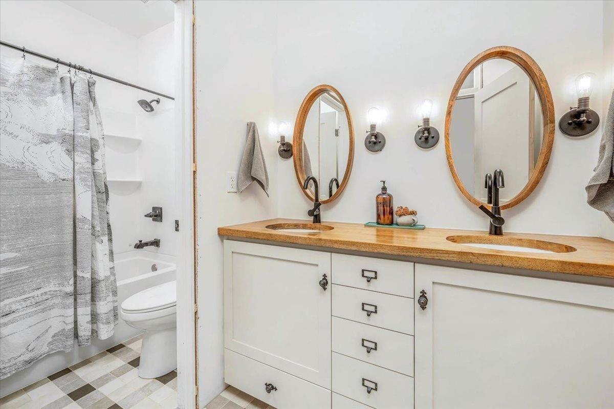 22654 Cobblestone Lane Sanger, CA 93657 - Photo 39 of 64 a bathroom with a granite countertop sink a toilet and a mirror