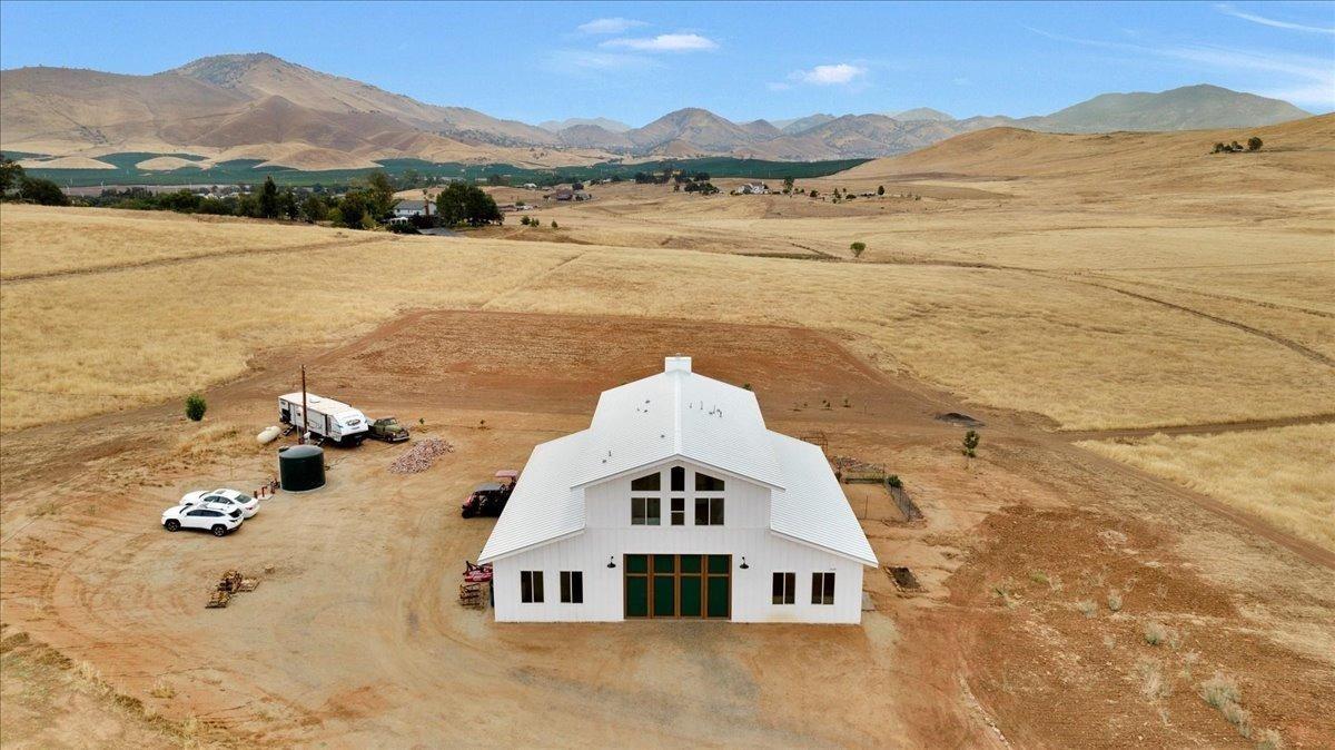 22654 Cobblestone Lane Sanger, CA 93657 - Photo 7 of 64 a front view of a house with a lake view