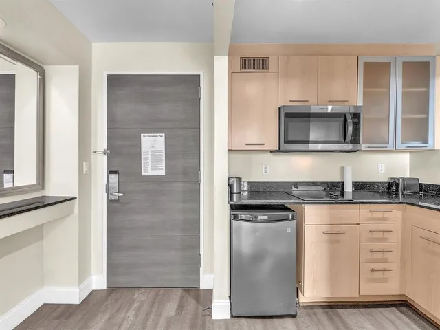 a kitchen with granite countertop cabinets stainless steel appliances and a counter space
