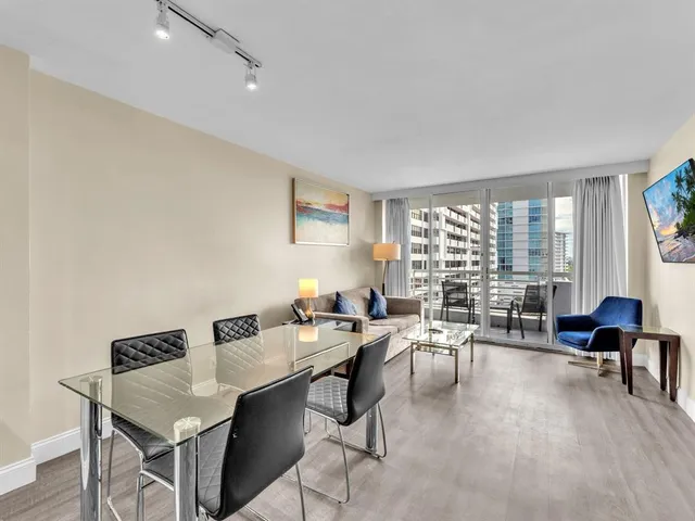 a living room with furniture potted plant and a large window