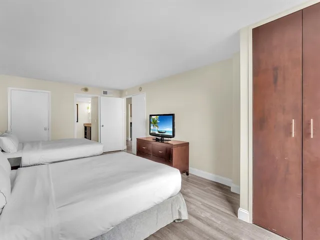 a bedroom with a bed and a flat screen tv