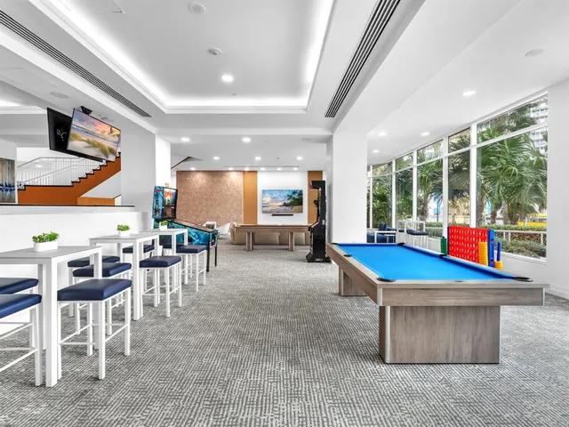 a room with lots of furniture and a large window