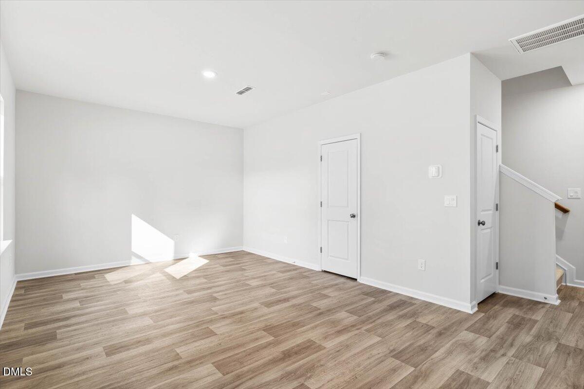 1387 Hasse Avenue Apex, NC 27502 - Photo 2 of 27 a view of empty room with wooden floor