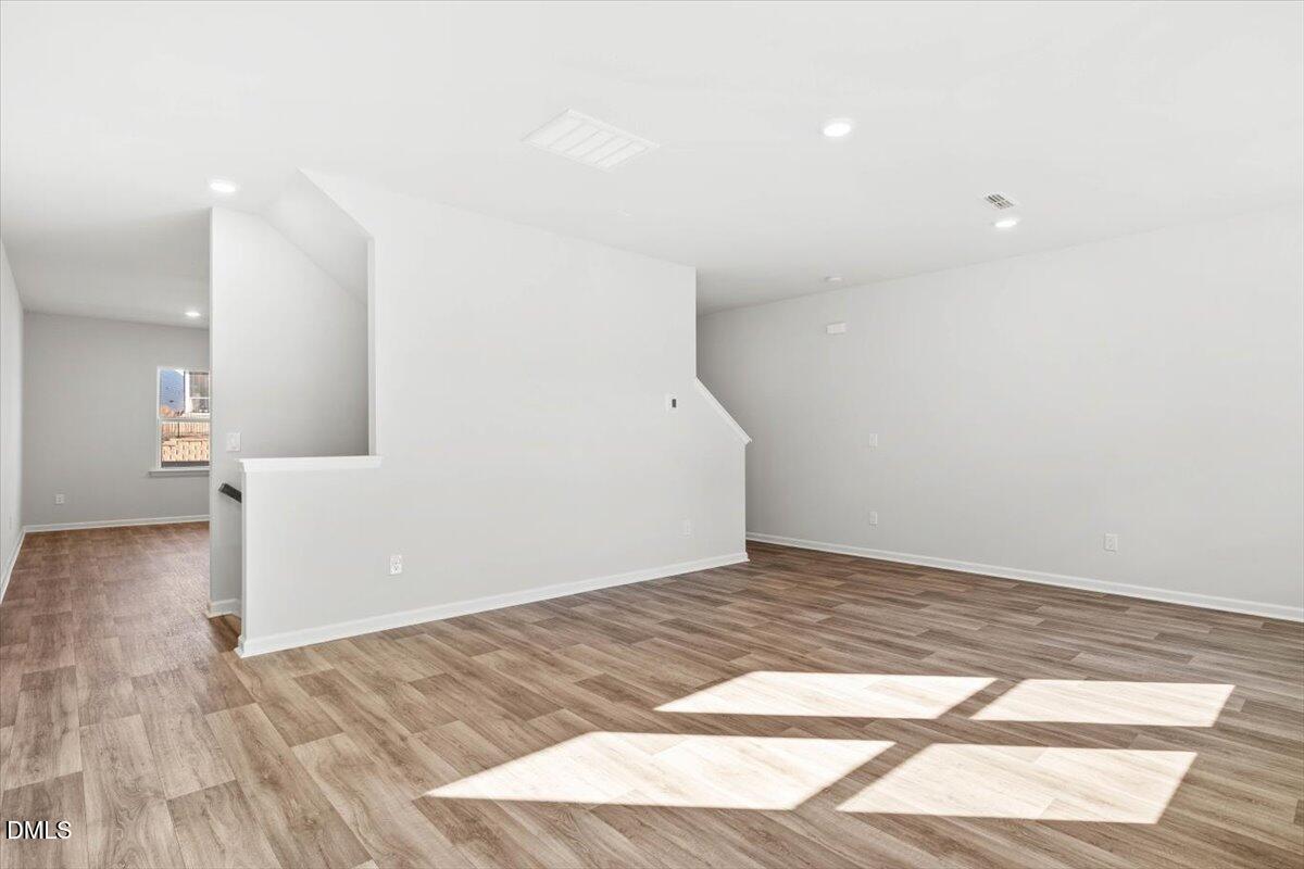 1387 Hasse Avenue Apex, NC 27502 - Photo 6 of 27 a view of empty room with wooden floor