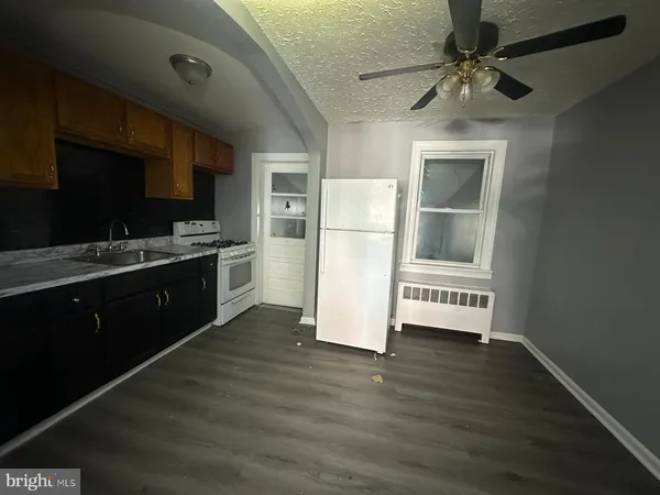 a kitchen with a refrigerator a stove top oven a sink and dishwasher