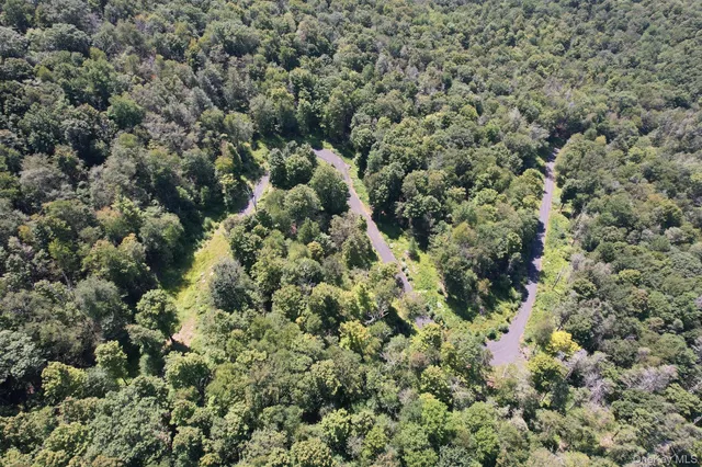 an aerial view of a houses with a yard