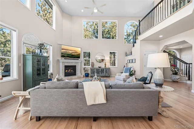 a living room with fireplace furniture and a large window
