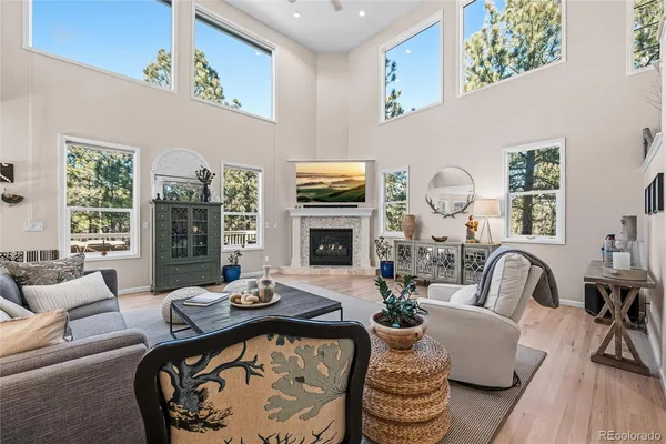 a living room with furniture fireplace and flat screen tv