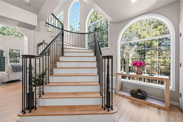 a view of entryway with wooden floor and windows
