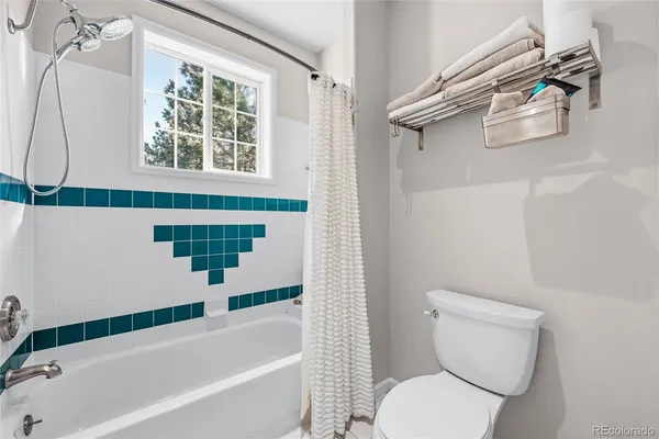 a bathroom with a sink mirror and toilet