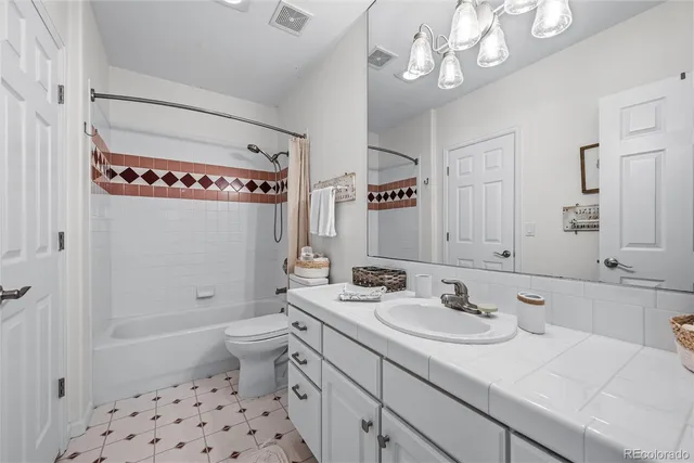 a spacious bedroom with a bed and a couch