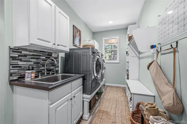 a view of a patio with table and chairs with wooden floor and fence