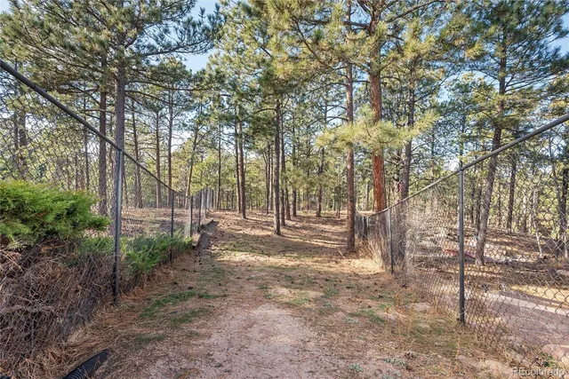 a view of an house with backyard space and balcony