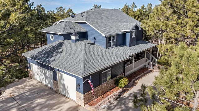 a front view of a house with a tree
