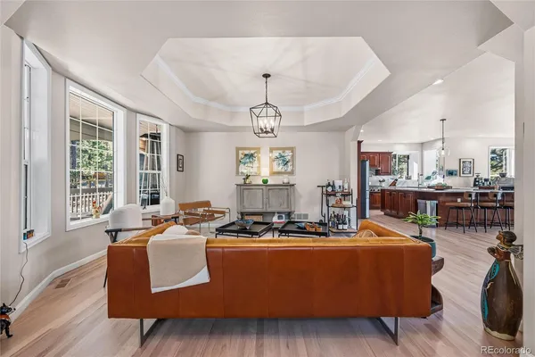 a living room with furniture pool table and windows