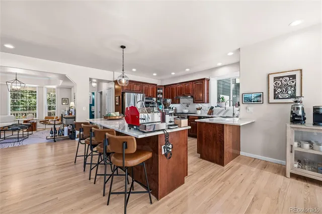 a kitchen that has a lot of cabinets in it with a dining table and chairs