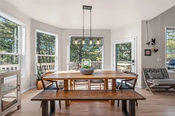 a dining room with furniture window and wooden floor