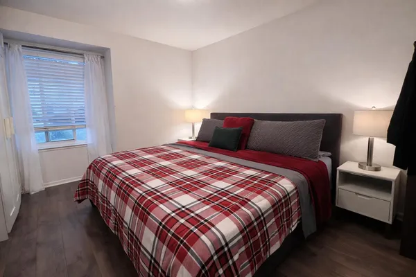 a bedroom with a bed and window