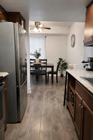 a kitchen with refrigerator and furniture