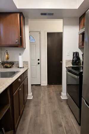 a kitchen with a sink stove and refrigerator