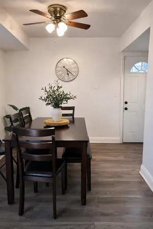 a view of a dining room with furniture and wooden floor