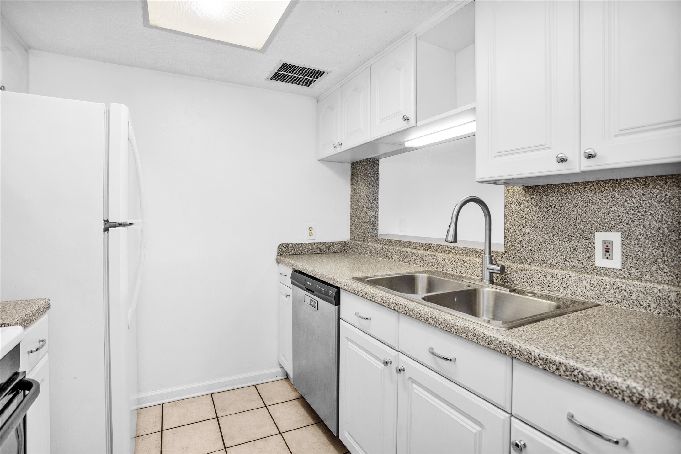 9541 Clanton Street Houston, TX 77080 - Photo 13 of 44 a close view of a sink and cabinets