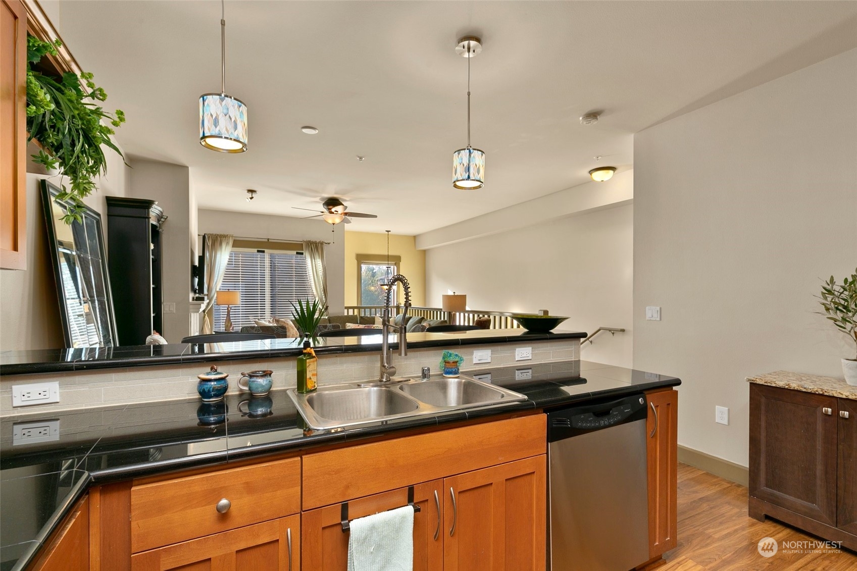 2115 201st Place Southeast, Unit B3 Bothell, WA 98012 - Photo 11 of 25 a kitchen with stainless steel appliances granite countertop a sink a stove and a wooden floors