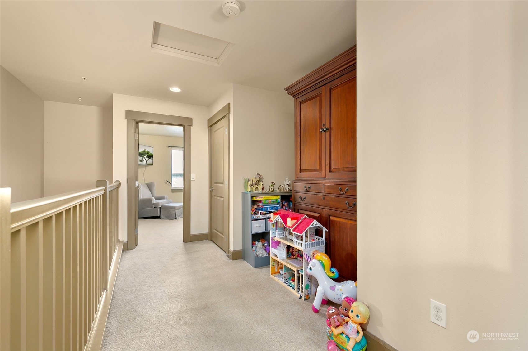 2115 201st Place Southeast, Unit B3 Bothell, WA 98012 - Photo 15 of 25 a view of a hallway to a livingroom with shelves