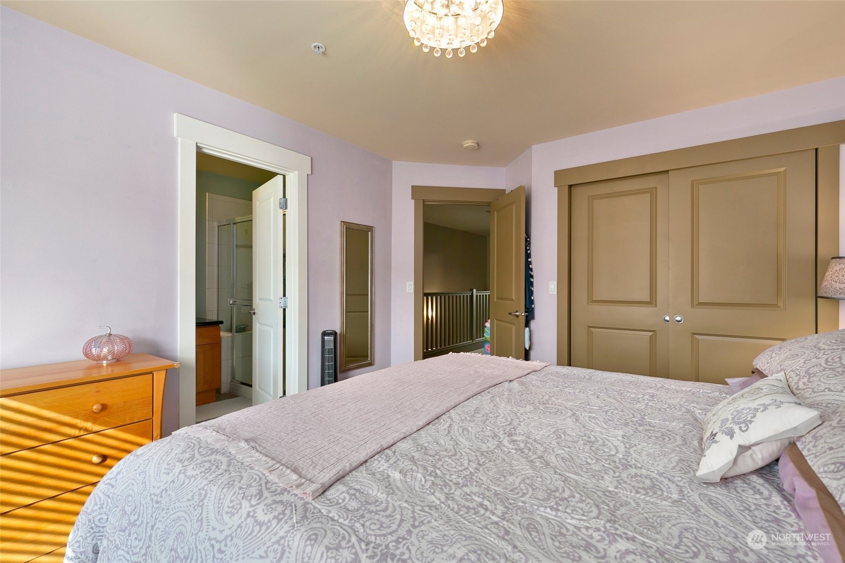 2115 201st Place Southeast, Unit B3 Bothell, WA 98012 - Photo 17 of 25 a bedroom with a bed and a chandelier