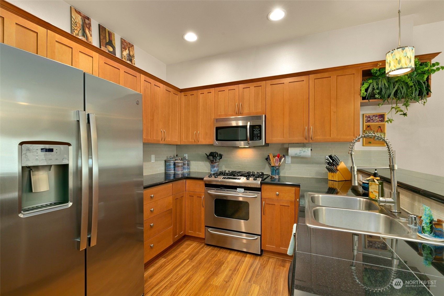 2115 201st Place Southeast, Unit B3 Bothell, WA 98012 - Photo 9 of 25 a kitchen with stainless steel appliances granite countertop a refrigerator a stove top oven a sink and dishwasher