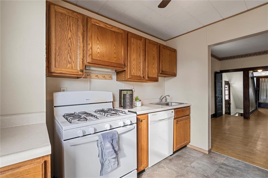325 Walnut Street Vandergrift, PA 15690 - Photo 8 of 29 a kitchen with a stove a sink and a refrigerator