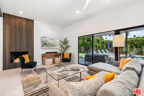 a living room with furniture and a dresser