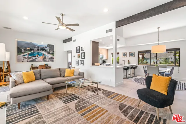 a kitchen with a sink a window and chairs