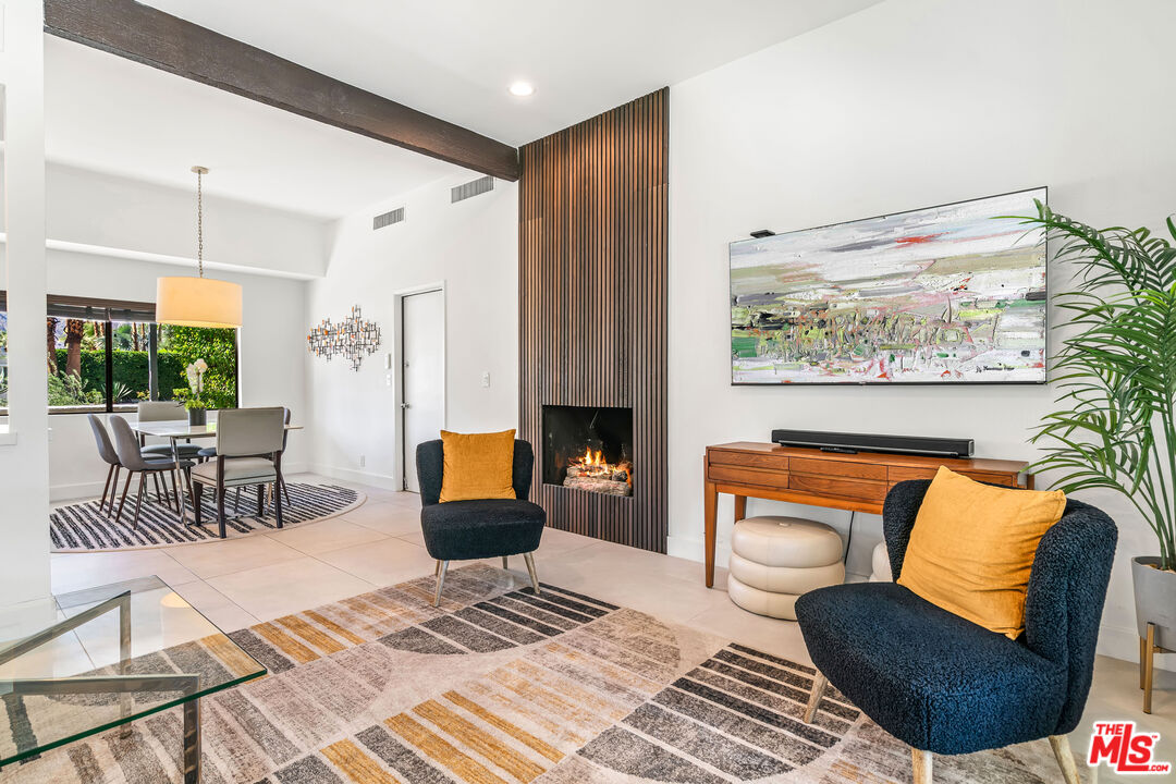 544 North Tercero Circle Palm Springs, CA 92262 - Photo 18 of 75 a living room with furniture a large window and a fireplace