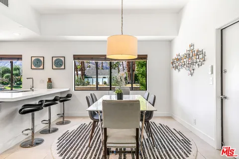 a kitchen with stainless steel appliances kitchen island granite countertop a refrigerator and microwave