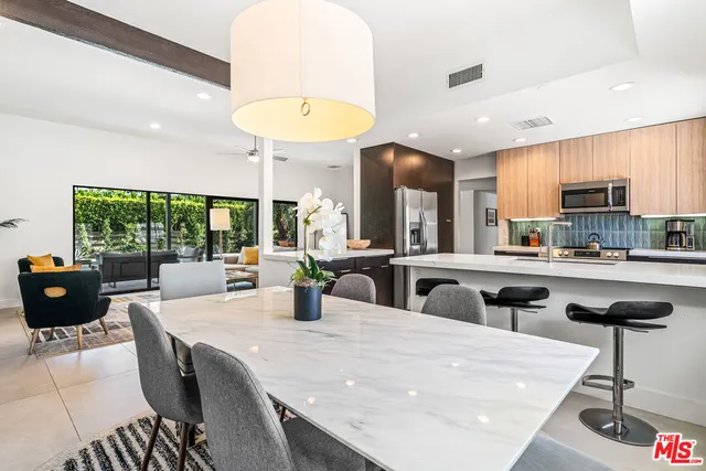 a kitchen with stainless steel appliances granite countertop a refrigerator and a sink
