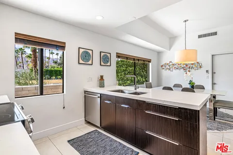 a kitchen with sink and view of living room