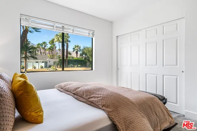 a view of a swimming pool with a patio and a garden