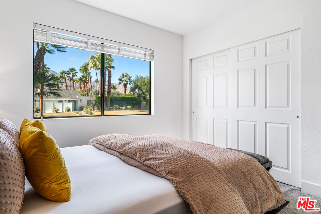 544 North Tercero Circle Palm Springs, CA 92262 - Photo 32 of 75 a bedroom with a bed and a large window