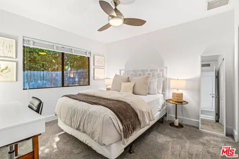 a front view of a house with a yard table and chairs