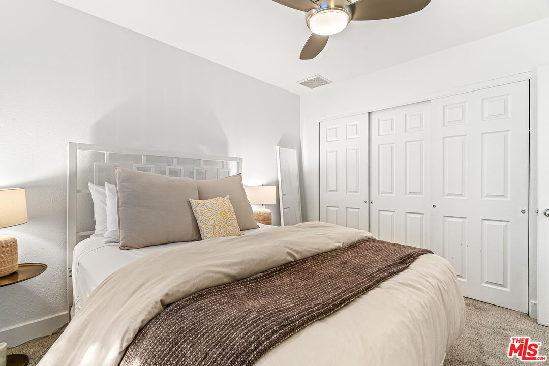 544 North Tercero Circle Palm Springs, CA 92262 - Photo 34 of 75 a bedroom with a large bed and a chandelier