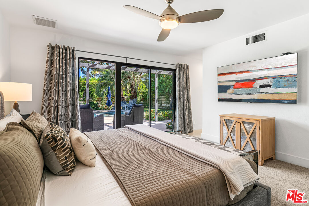 544 North Tercero Circle Palm Springs, CA 92262 - Photo 37 of 75 a bedroom with a bed and a painting on the wall