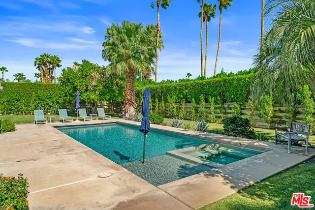 a view of a chairs and table in patio with a fire pit