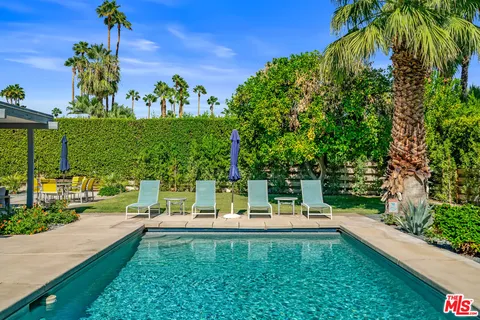 a view of swimming pool with a table and chairs