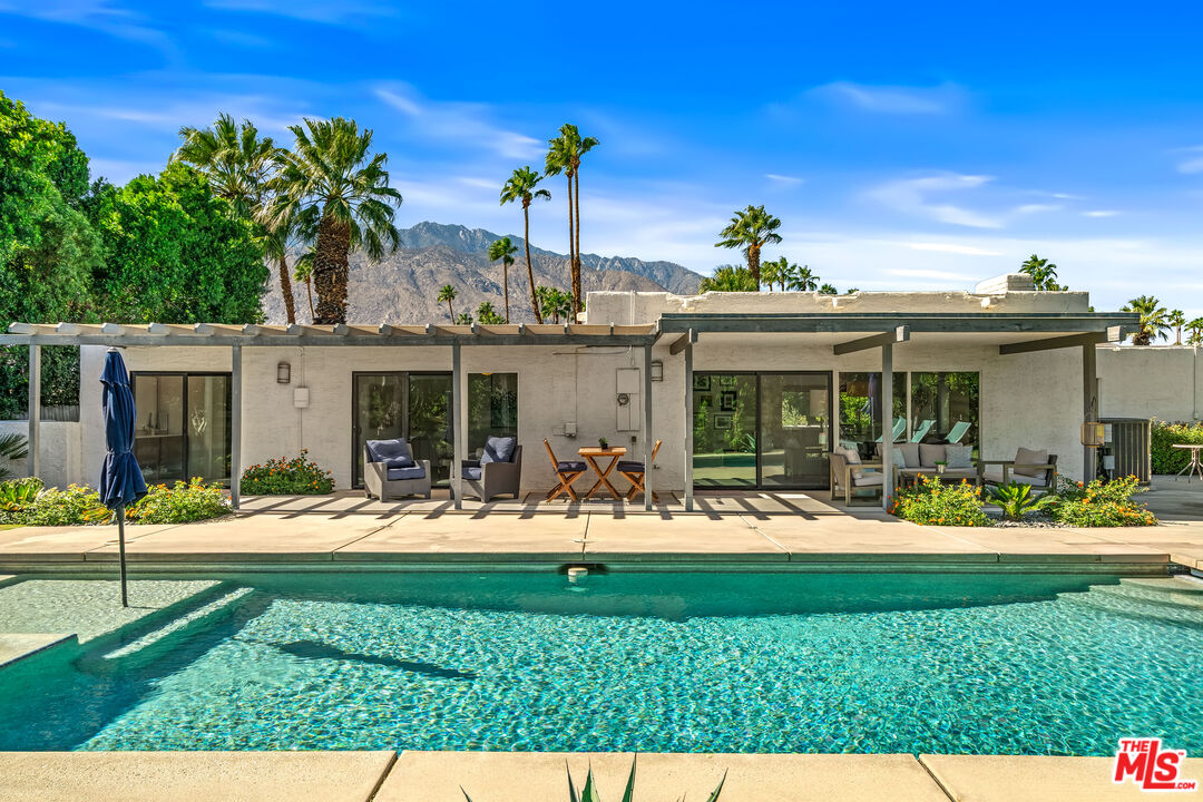 544 North Tercero Circle Palm Springs, CA 92262 - Photo 48 of 75 a front view of a house with a yard table and chairs