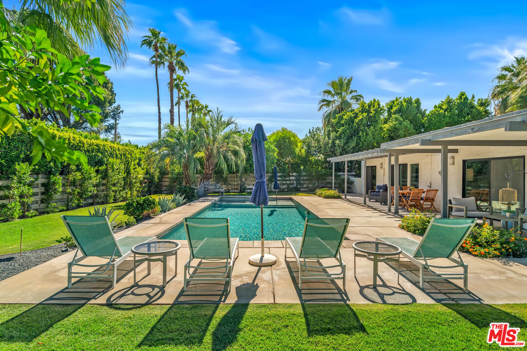 544 North Tercero Circle Palm Springs, CA 92262 - Photo 52 of 75 a view of a patio with table and chairs potted plants with wooden fence