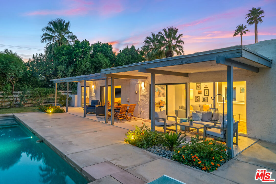 544 North Tercero Circle Palm Springs, CA 92262 - Photo 71 of 75 a view of a patio with table and chairs potted plants and palm tree