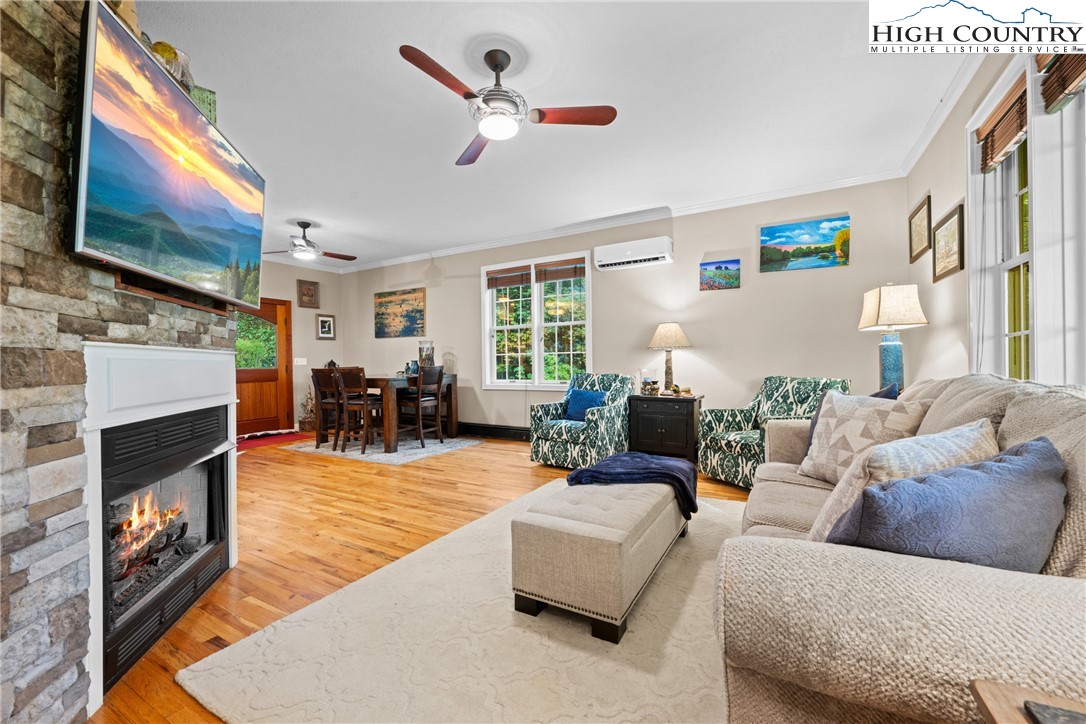 126 Moore Mountain Road Vilas, NC 28692 - Photo 12 of 43 a living room with furniture flat screen tv and a fireplace